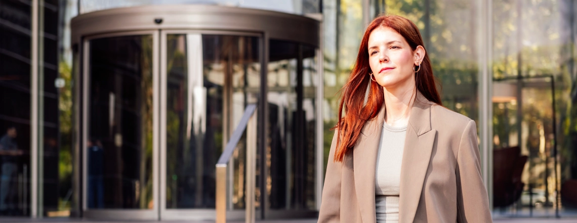 beautiful-european-lady-looking-professional-coming-out-from-automatic-curved-sliding-door