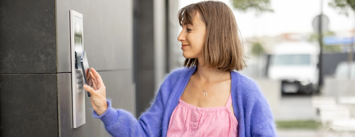 a-british-lady-using-her-phone-to-unlock-the-electronic-lock-of-door